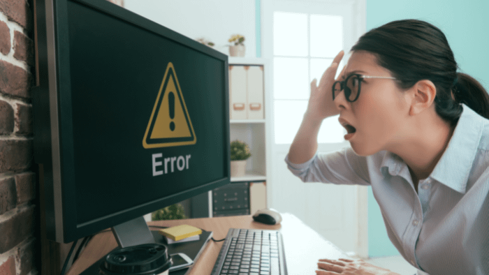 Mother looking at error message on computer screen to represent parenting missteps.