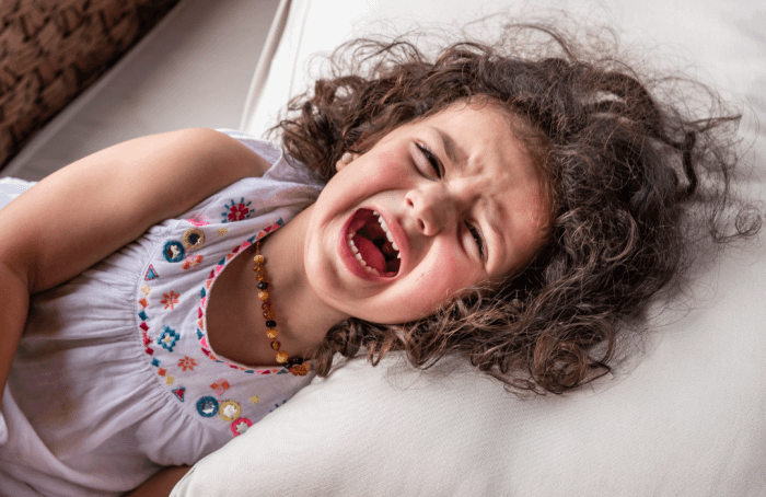 Young girl screaming. An example of a temper tantrum.