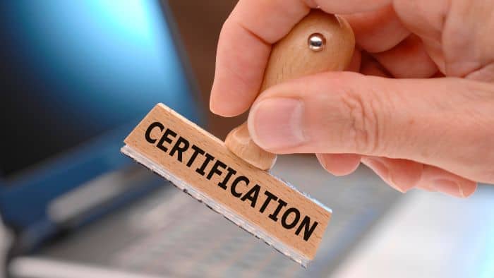 Person placing Certification Stamp on a paper.